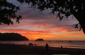 A long shot of the sunset and the beach